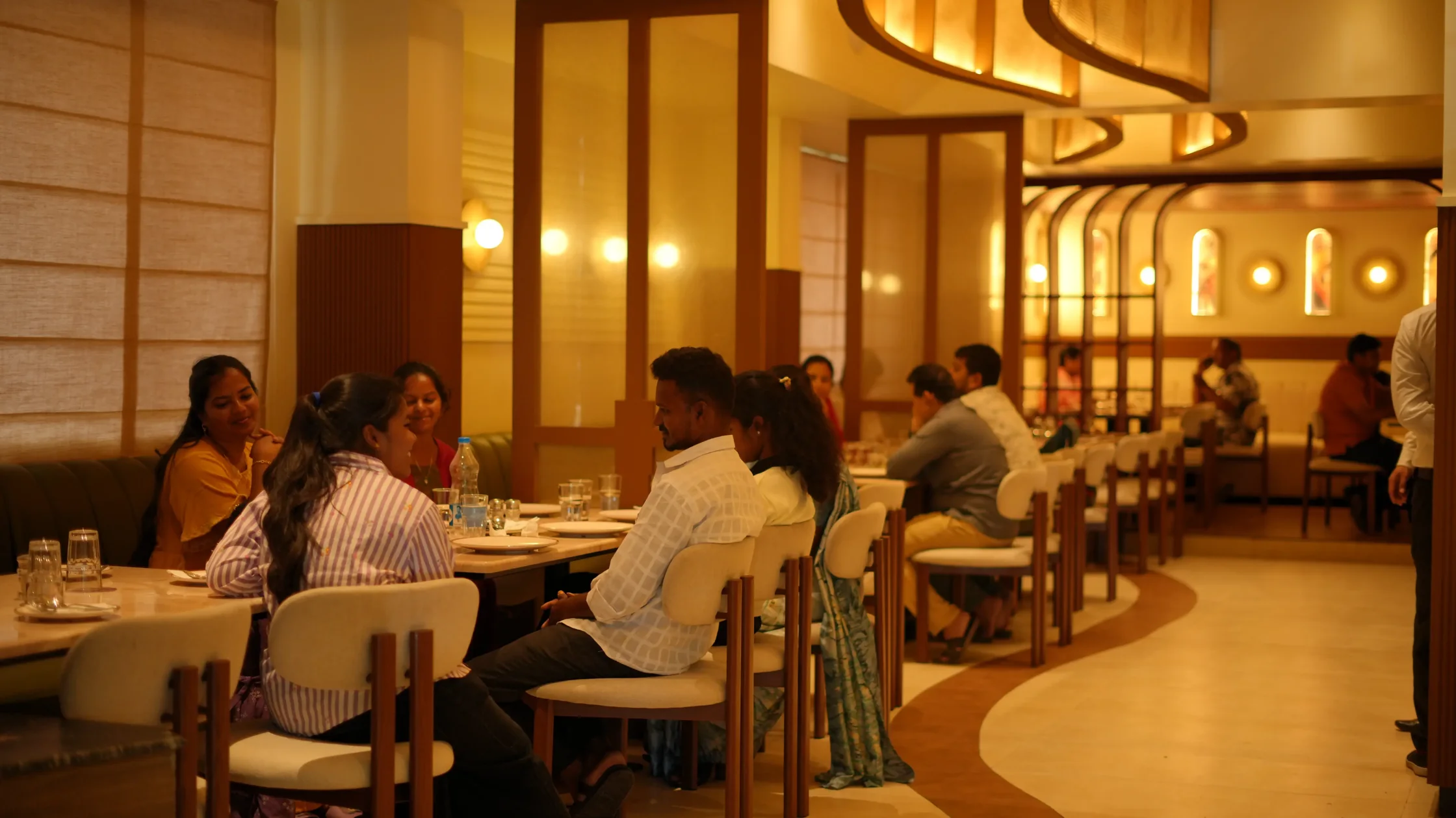 Family dining at a warmly lit restaurant in Mysore.
